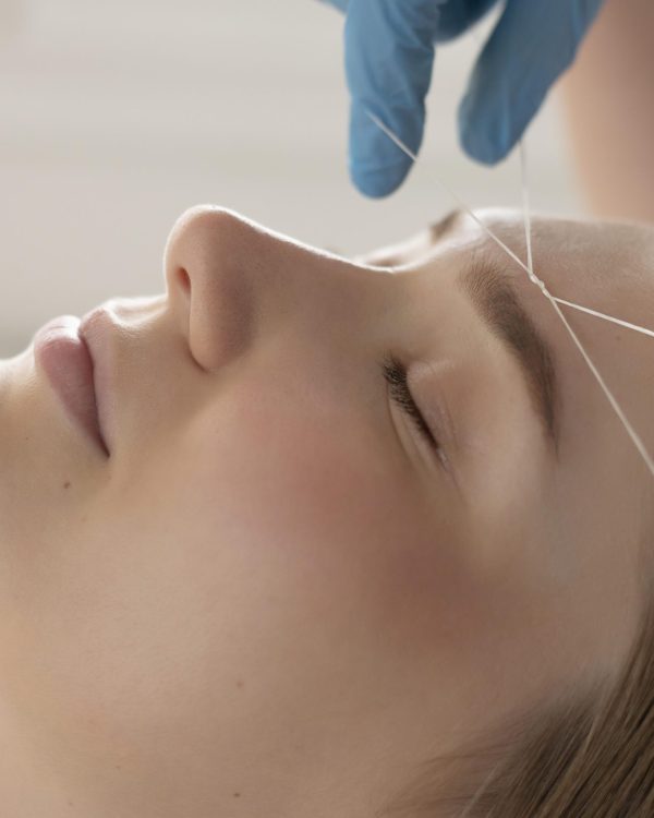close-up-young-woman-getting-eyebrow-treatment