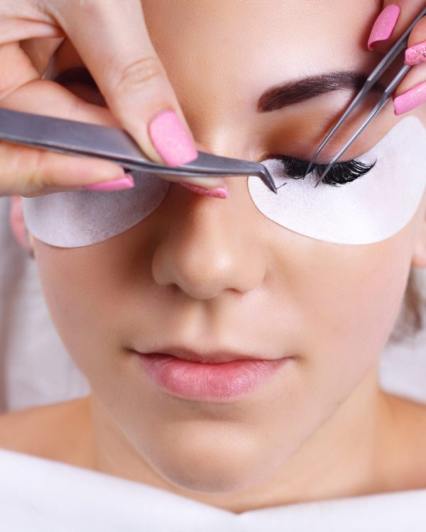 Eyelash Extension Procedure. Woman Eye with Long Eyelashes. Lashes. Close up, macro, selective focus