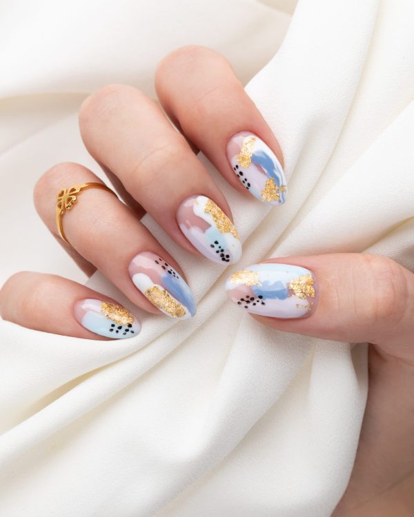 Woman's hand with fashionable nails holding fabric. Spring summer nail design. Manicure, pedicure beauty salon concept.