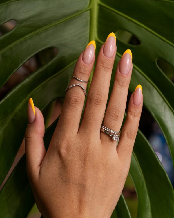 woman-showing-her-nail-art-fingernails-against-monster-leaf