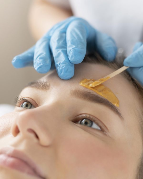 young-woman-getting-eyebrow-treatment-beauty-salon (1)